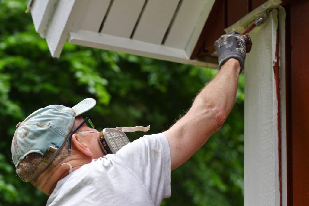 Expert Interior and Exterior Painting | King & Pierce Counties A man painting house exterior with white color